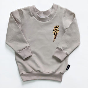 Women’s oat “leopard print lightning bolt” Sweater
